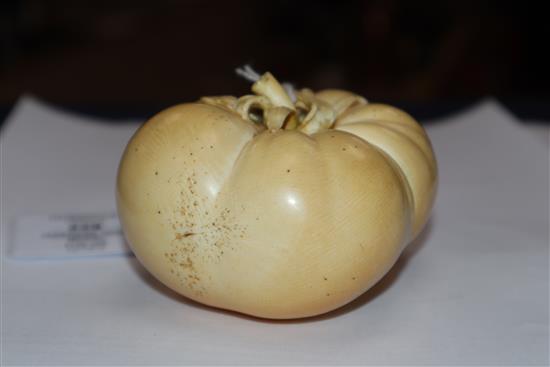 A good Japanese ivory model of a persimmon fruit, early 20th century, three character signature and seal, remnants of colouring to base